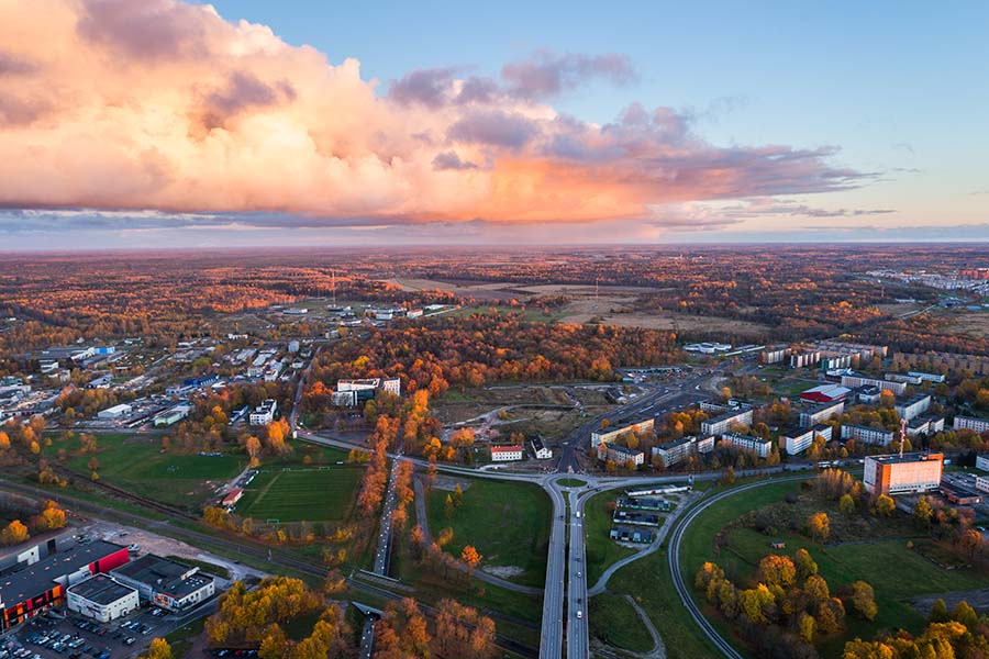 Ohio - Aerial View of Homes and Buildings Surrounded By Fall Foliage in Ohio at Sunset